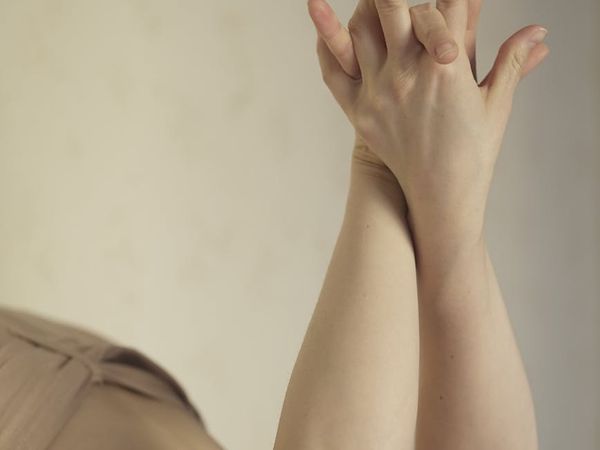Close-up of hands in a mindful gesture during an exercise.